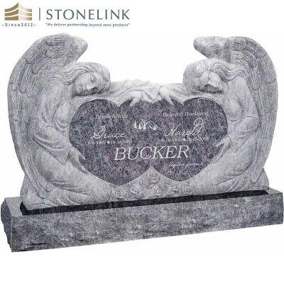 Kneeling angels embracing double heart granite headstone